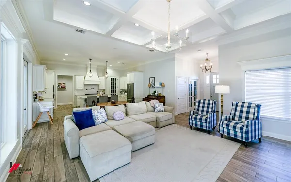 a living room with furniture and a chandelier