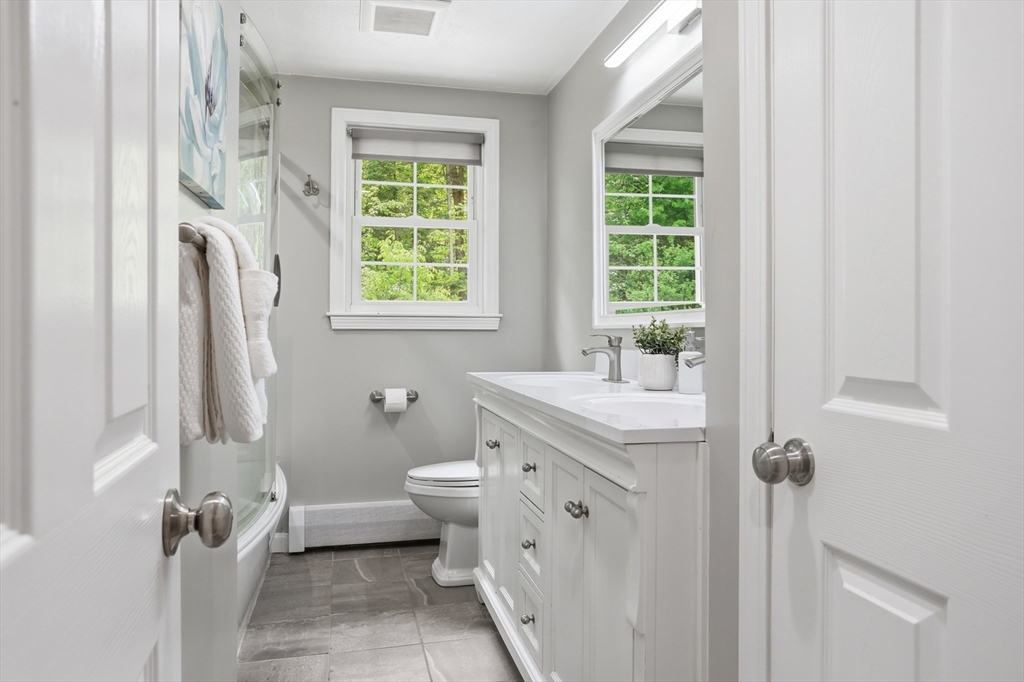 33 Simon Willard Road Acton, MA 01720 - Photo 17 of 42 a bathroom with a granite countertop toilet a sink and a window