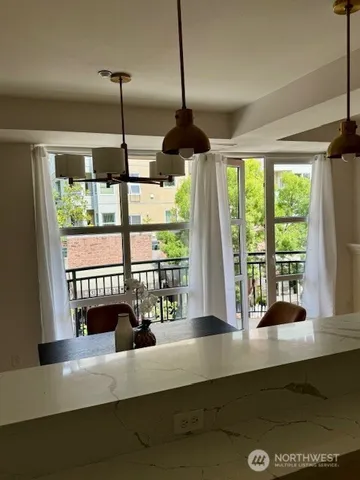 a dining room with fireplace furniture and a large window