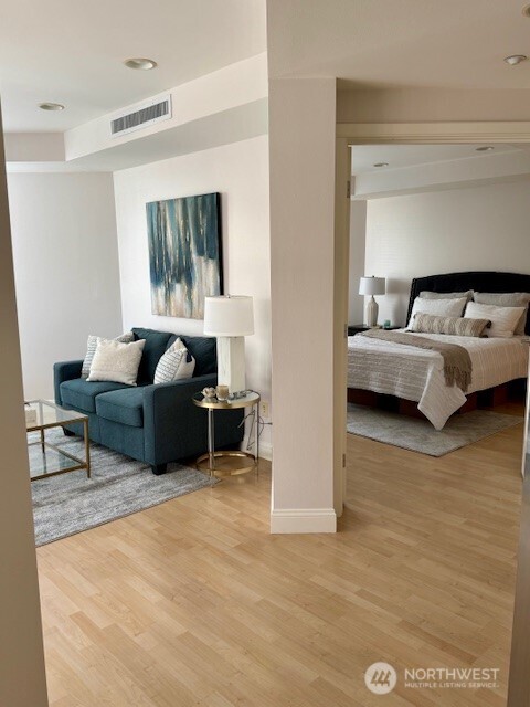 10047 Main Street, Unit 319 Bellevue, WA 98004 - Photo 17 of 30 a living room with furniture and a flat screen tv