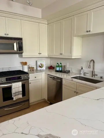 a kitchen with a sink stove and microwave