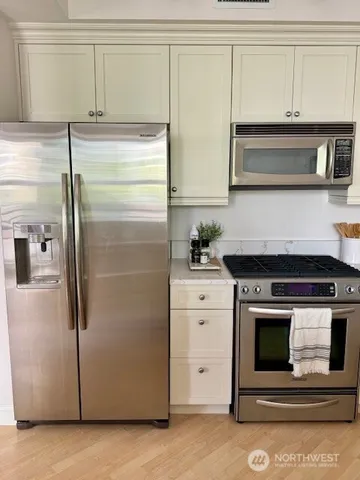 a kitchen with cabinets and a refrigerator