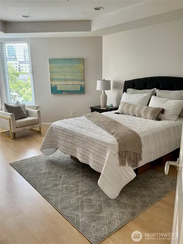 a bedroom with a bed and wooden floor