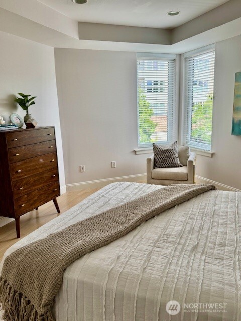 10047 Main Street, Unit 319 Bellevue, WA 98004 - Photo 22 of 30 a bedroom with a bed and a window