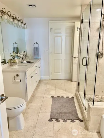 a bathroom with a granite countertop sink toilet and shower