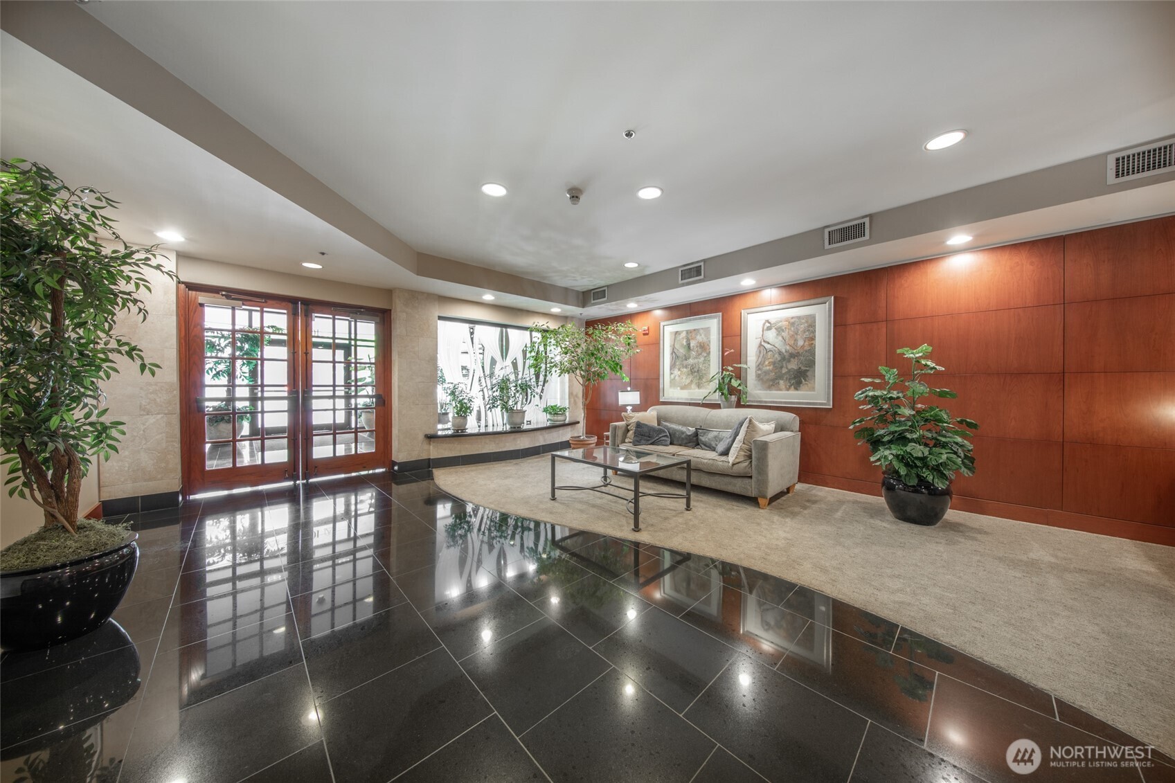 10047 Main Street, Unit 319 Bellevue, WA 98004 - Photo 3 of 30 a lobby with furniture and potted plants