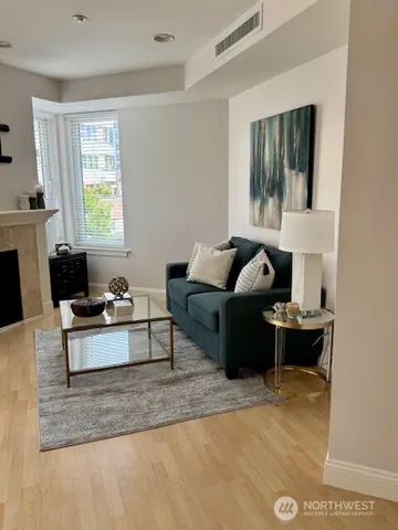 a living room with furniture wooden floor and a window