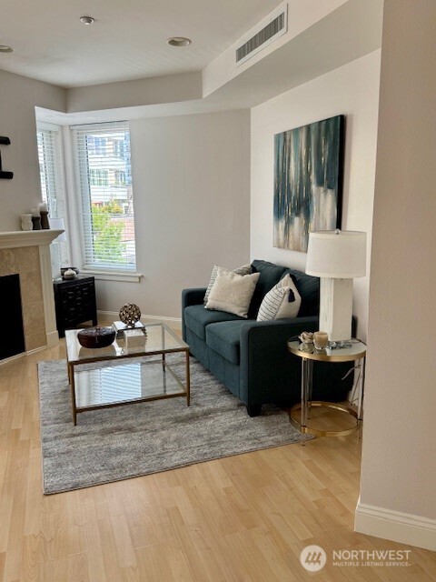 10047 Main Street, Unit 319 Bellevue, WA 98004 - Photo 6 of 30 a living room with furniture wooden floor and a window