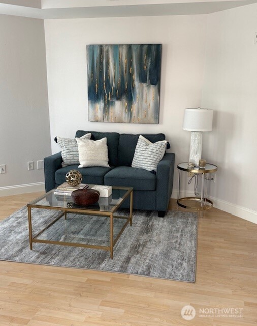 10047 Main Street, Unit 319 Bellevue, WA 98004 - Photo 7 of 30 a living room with furniture and a rug