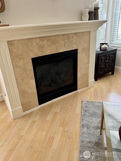 10047 Main Street, Unit 319 Bellevue, WA 98004 - Photo 9 of 30 a living room with a fireplace