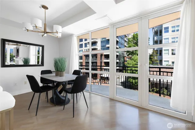 a view of a dining room with furniture and chandelier
