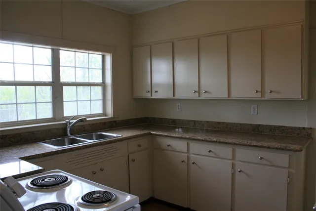 a kitchen with sink and window