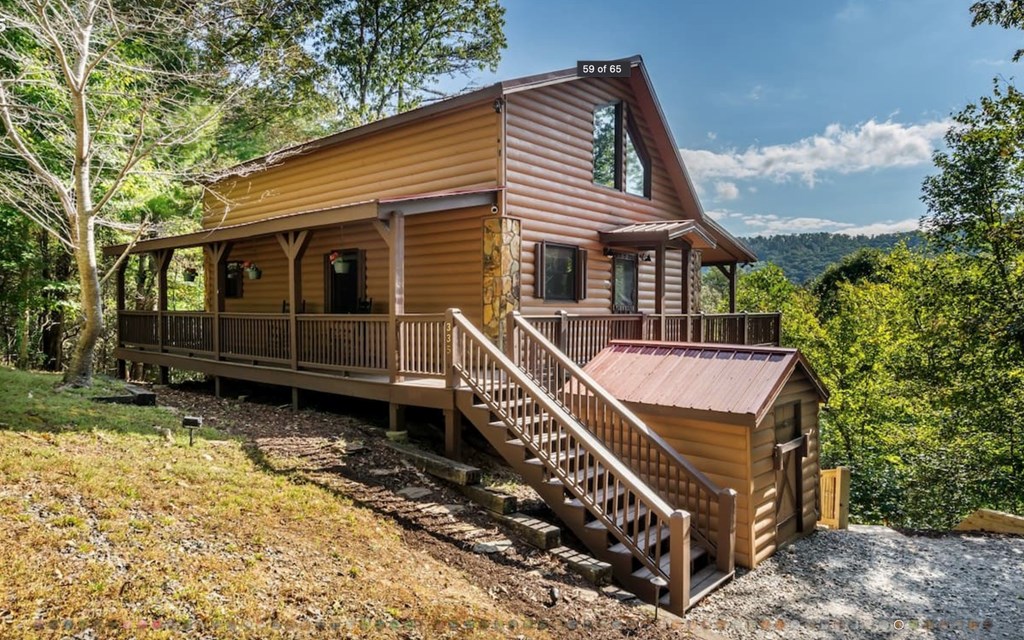 335 Mountain Laurel Lane Blue Ridge, GA 30513 - Photo 4 of 67 a front view of a house with a garden