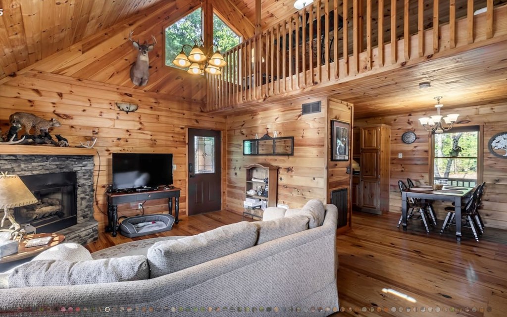 335 Mountain Laurel Lane Blue Ridge, GA 30513 - Photo 8 of 67 a living room with furniture a fireplace and a chandelier