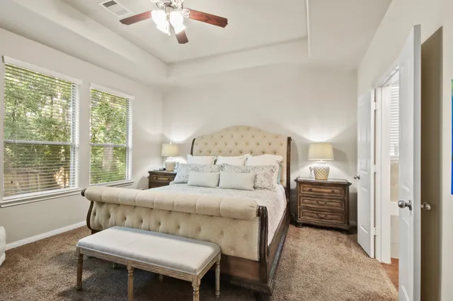 a bedroom with a bed and a chandelier