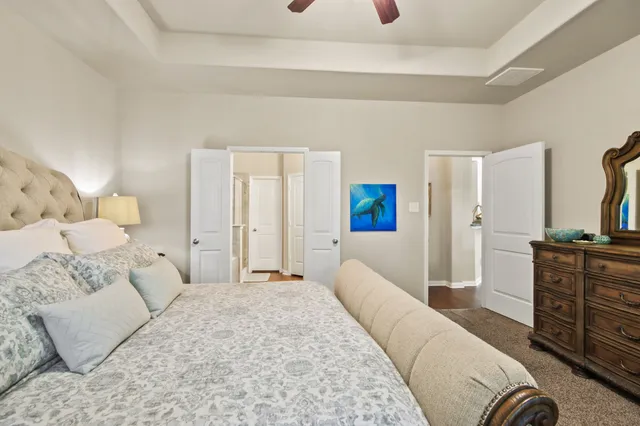 a spacious bedroom with a bed and furniture