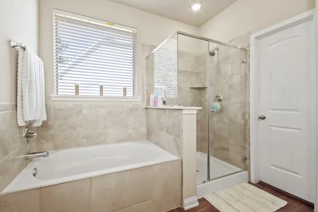 a white bath tub sitting next to a shower