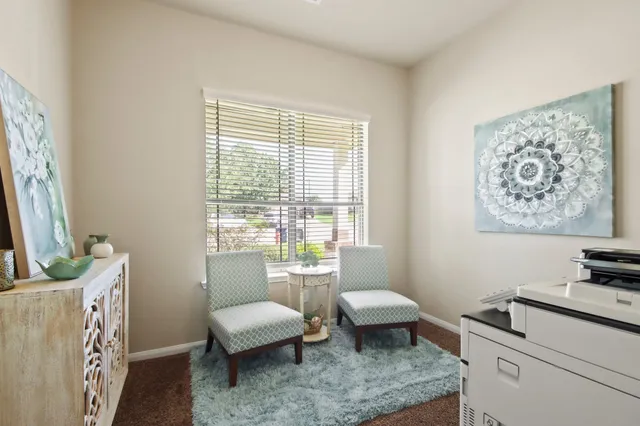 a living room with furniture and a window
