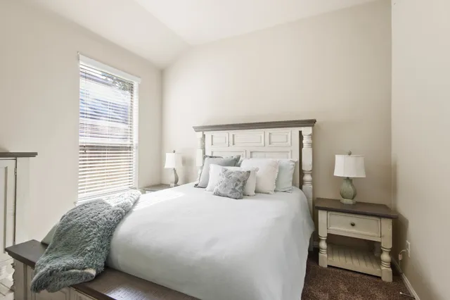 a bedroom with a bed and a night stand