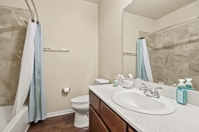 a bathroom with a sink toilet and shower