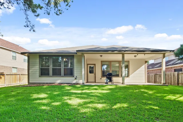 a view of a house with backyard and porch