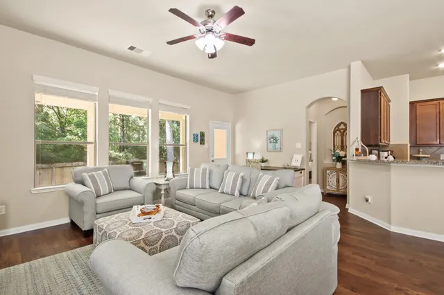 a living room with furniture and a large window