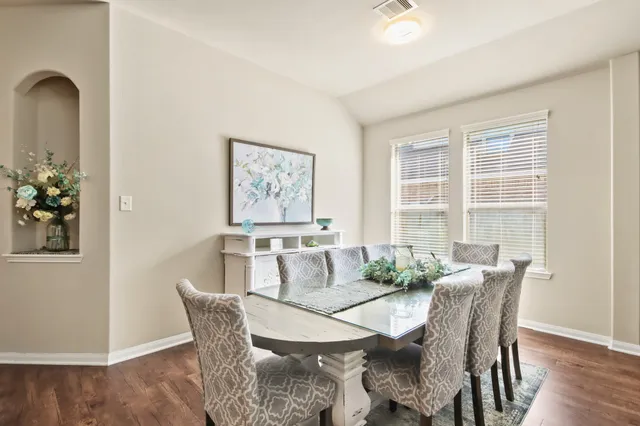 a view of a dining room with furniture and wooden floor