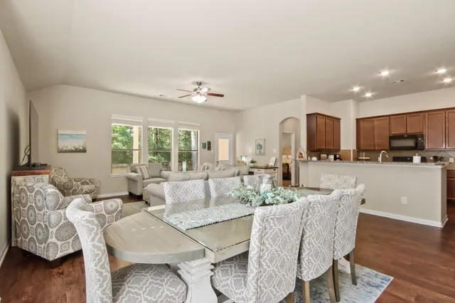 a living room with furniture and kitchen view