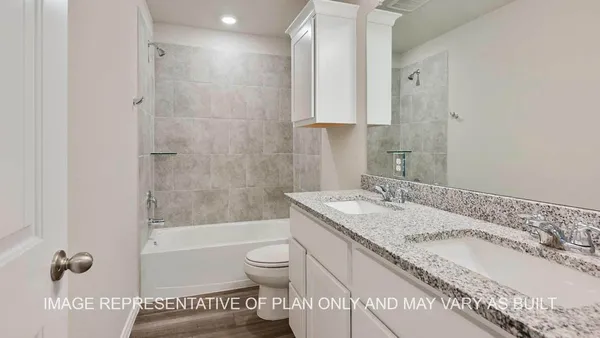 a bathroom with a granite countertop sink a toilet and bathtub