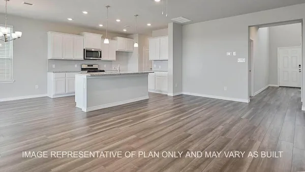 a view of kitchen with cabinets appliances and wooden floor