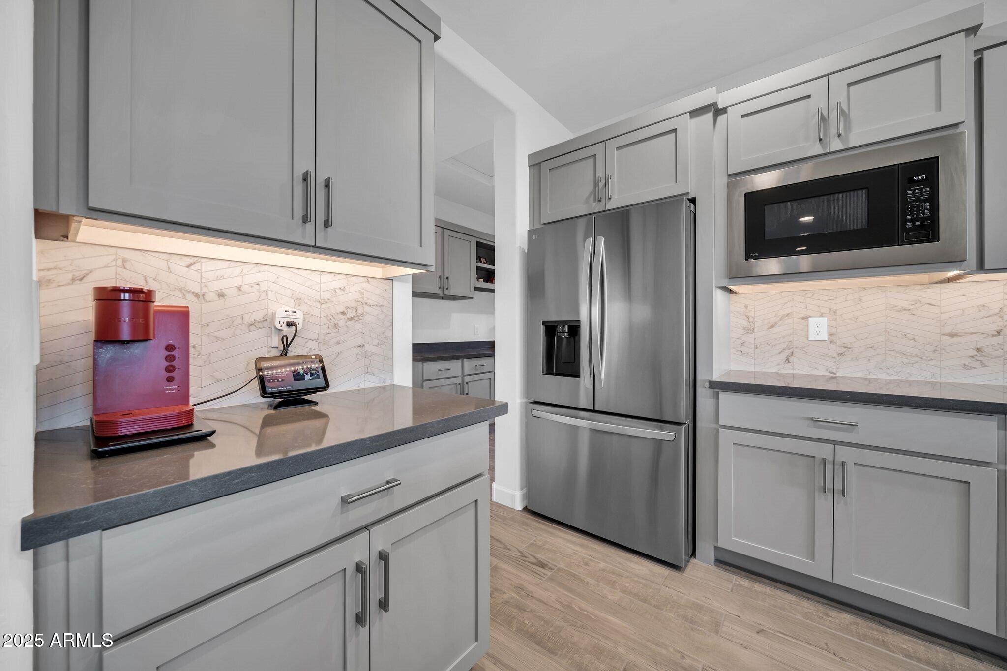 18212 East Parker Creek Road Rio Verde, AZ 85263 - Photo 13 of 47 a kitchen with stainless steel appliances granite countertop a refrigerator and a stove top oven