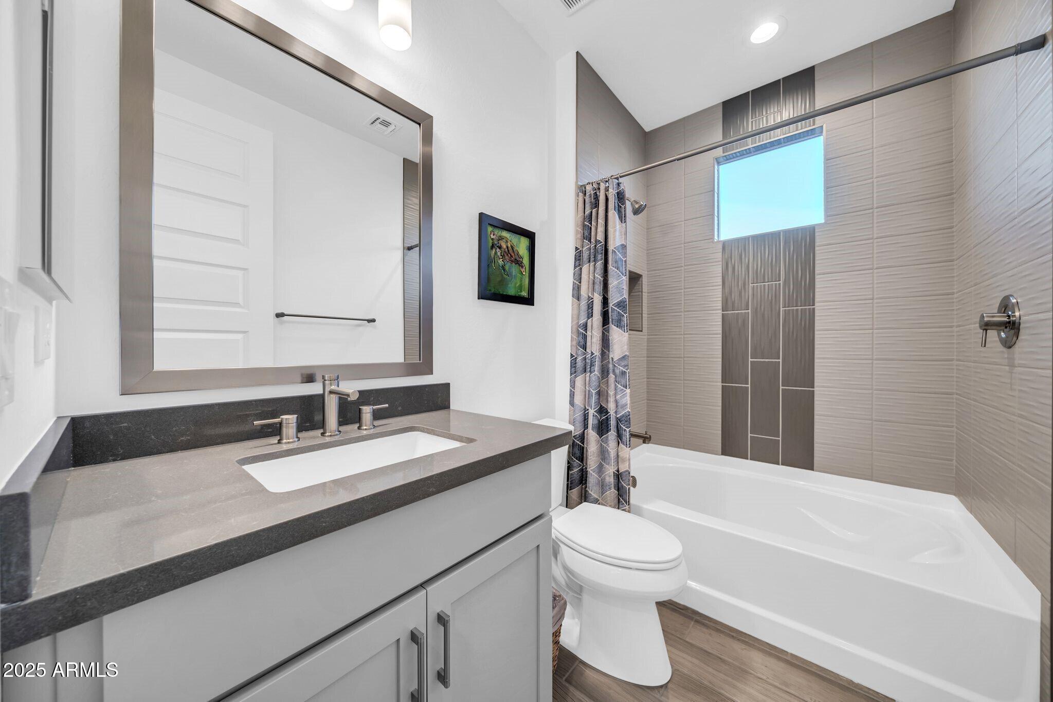 18212 East Parker Creek Road Rio Verde, AZ 85263 - Photo 21 of 47 a bathroom with a granite countertop sink toilet a large mirror and shower