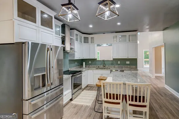 a kitchen with stainless steel appliances granite countertop a stove and a refrigerator