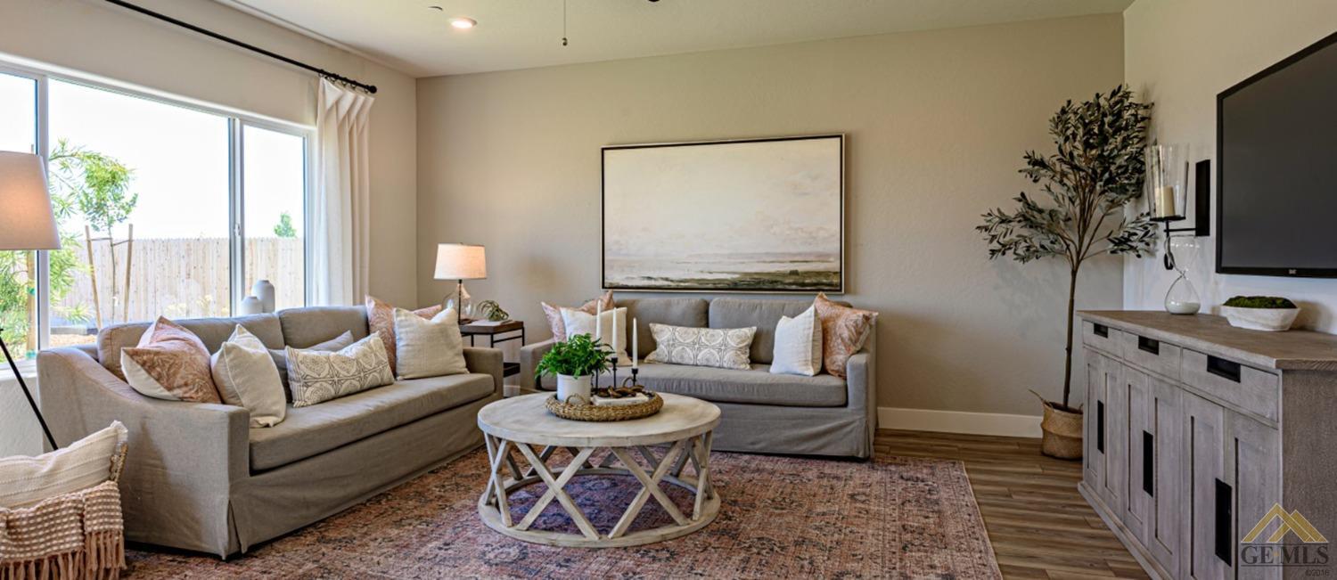 Undisclosed Address Bakersfield, CA 93313 - Photo 2 of 6 a living room with furniture a flat screen tv and a large window