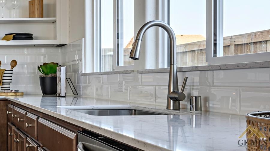 Undisclosed Address Bakersfield, CA 93313 - Photo 3 of 6 a kitchen with stainless steel appliances granite countertop a sink and a wooden cabinets