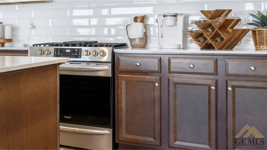 Undisclosed Address Bakersfield, CA 93313 - Photo 4 of 6 a kitchen with stainless steel appliances granite countertop a stove and a refrigerator