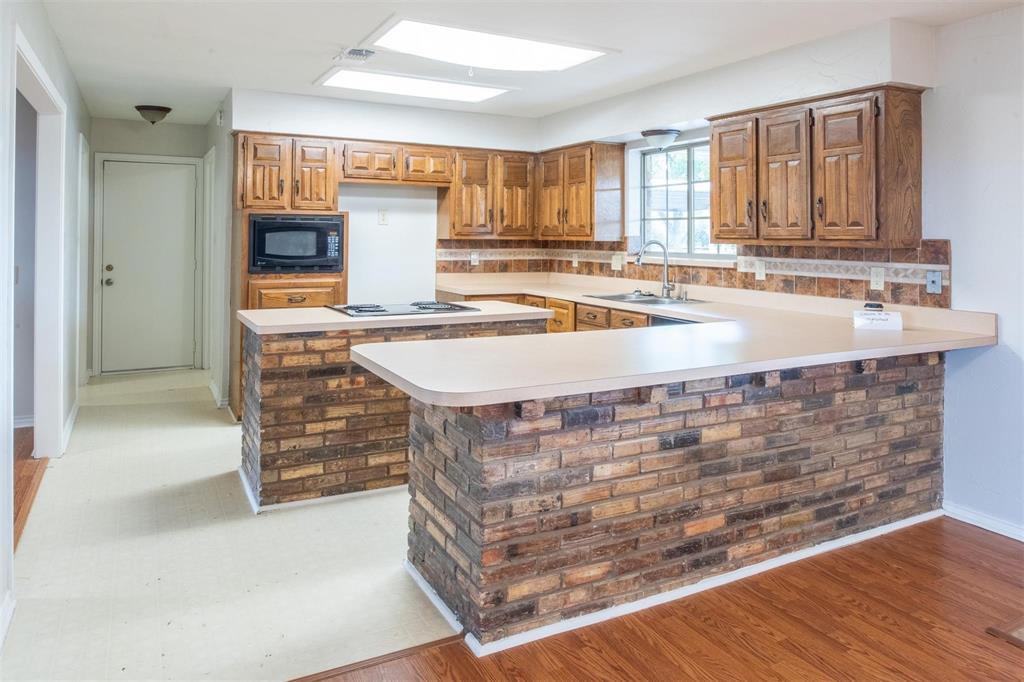 1850 Rock Ridge Road Lucas, TX 75002 - Photo 16 of 34 a kitchen with stainless steel appliances granite countertop a sink and a stove