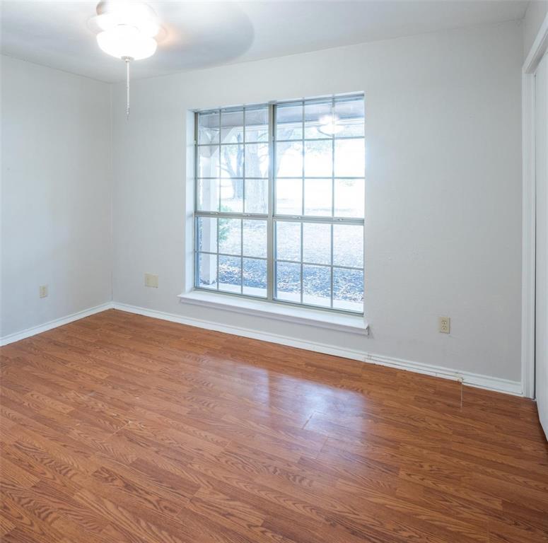 1850 Rock Ridge Road Lucas, TX 75002 - Photo 23 of 34 an empty room with wooden floor and windows