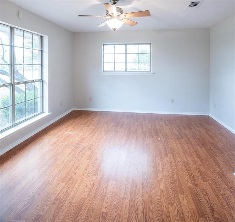 1850 Rock Ridge Road Lucas, TX 75002 - Photo 24 of 34 an empty room with wooden floor chandelier fan and windows