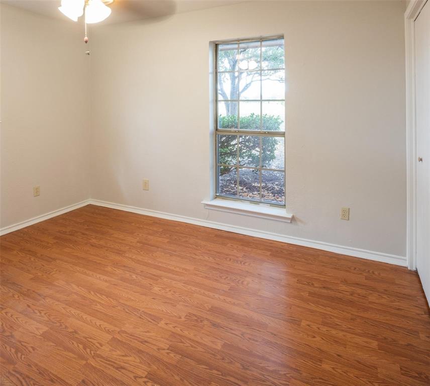 1850 Rock Ridge Road Lucas, TX 75002 - Photo 26 of 34 an empty room with wooden floor and windows