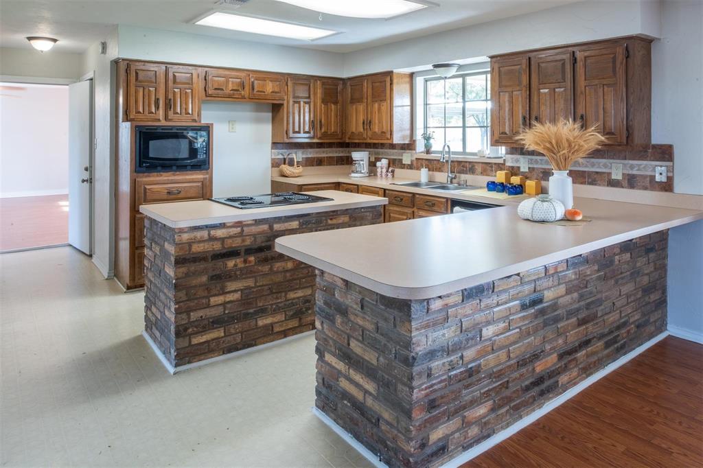 1850 Rock Ridge Road Lucas, TX 75002 - Photo 28 of 34 a kitchen with kitchen island a sink stove and cabinets