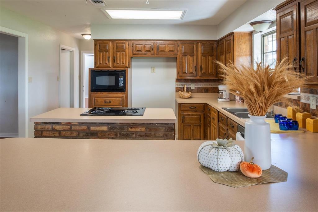 1850 Rock Ridge Road Lucas, TX 75002 - Photo 29 of 34 a kitchen with stainless steel appliances granite countertop a sink and a stove