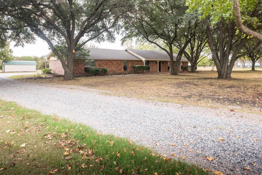 1850 Rock Ridge Road Lucas, TX 75002 - Photo 7 of 34 a front view of a house with a yard and garage