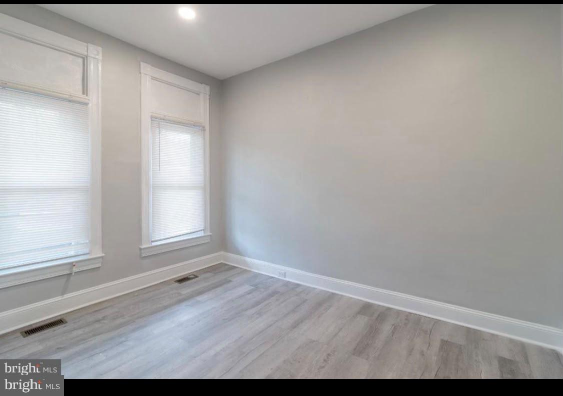 1626 Appleton Street Baltimore, MD 21217 - Photo 7 of 18 a view of empty room with wooden floor and fan