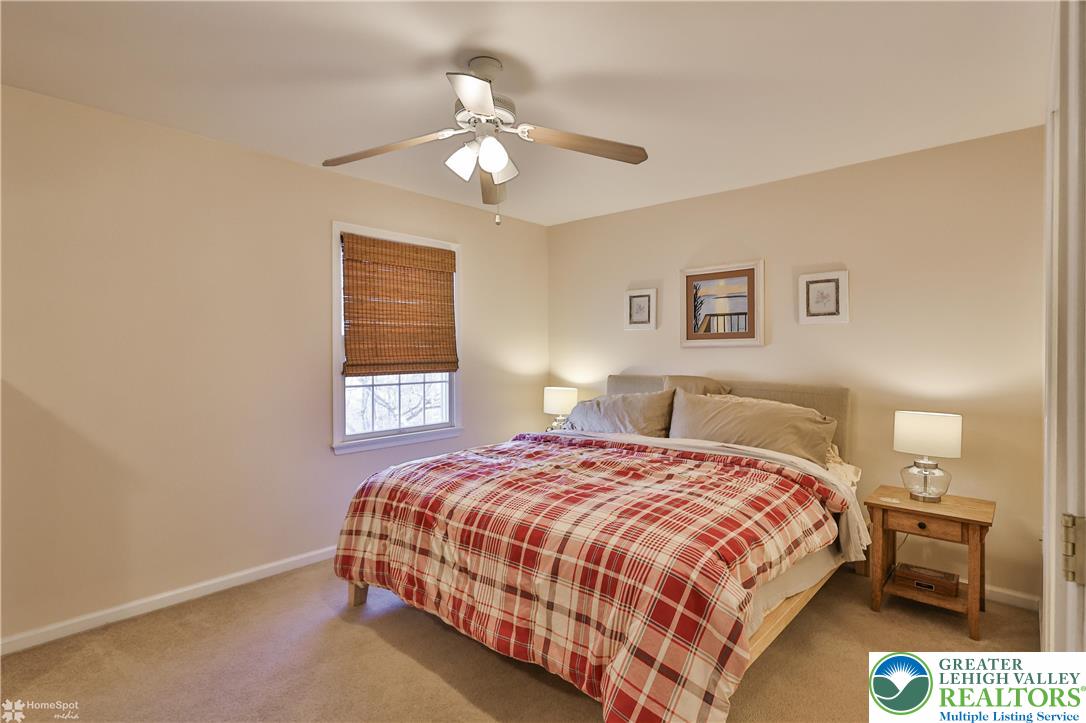521 South New Street Nazareth, PA 18064 - Photo 17 of 29 a bedroom with a bed and a chandelier
