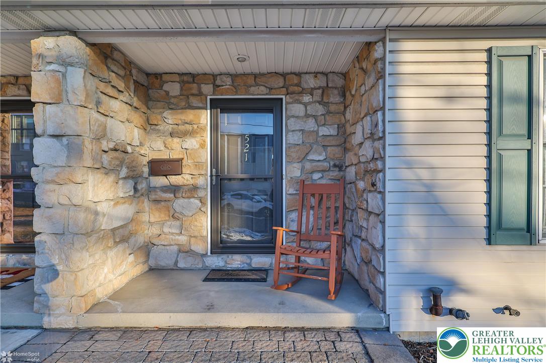 521 South New Street Nazareth, PA 18064 - Photo 2 of 29 a brick building with a bench in front of door
