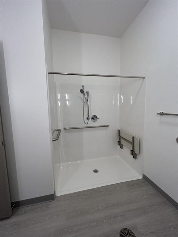 626 Main Street, Unit 110 Dennis, MA 02639 - Photo 7 of 14 a bathroom with a glass shower door