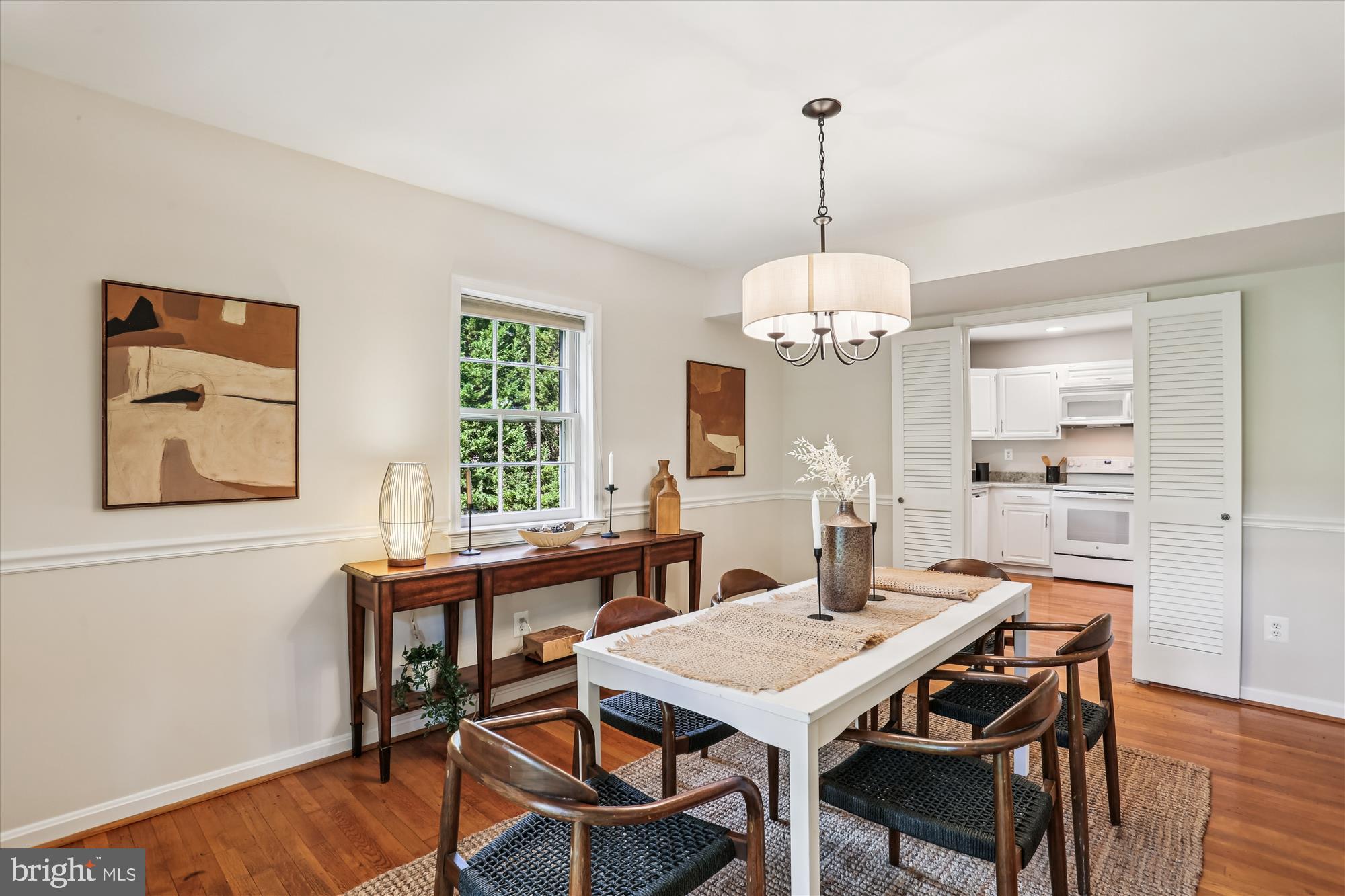 6734 Hillandale Road, Unit 9 Chevy Chase, MD 20815 - Photo 16 of 51 Dining room with chair rail and new chandelier