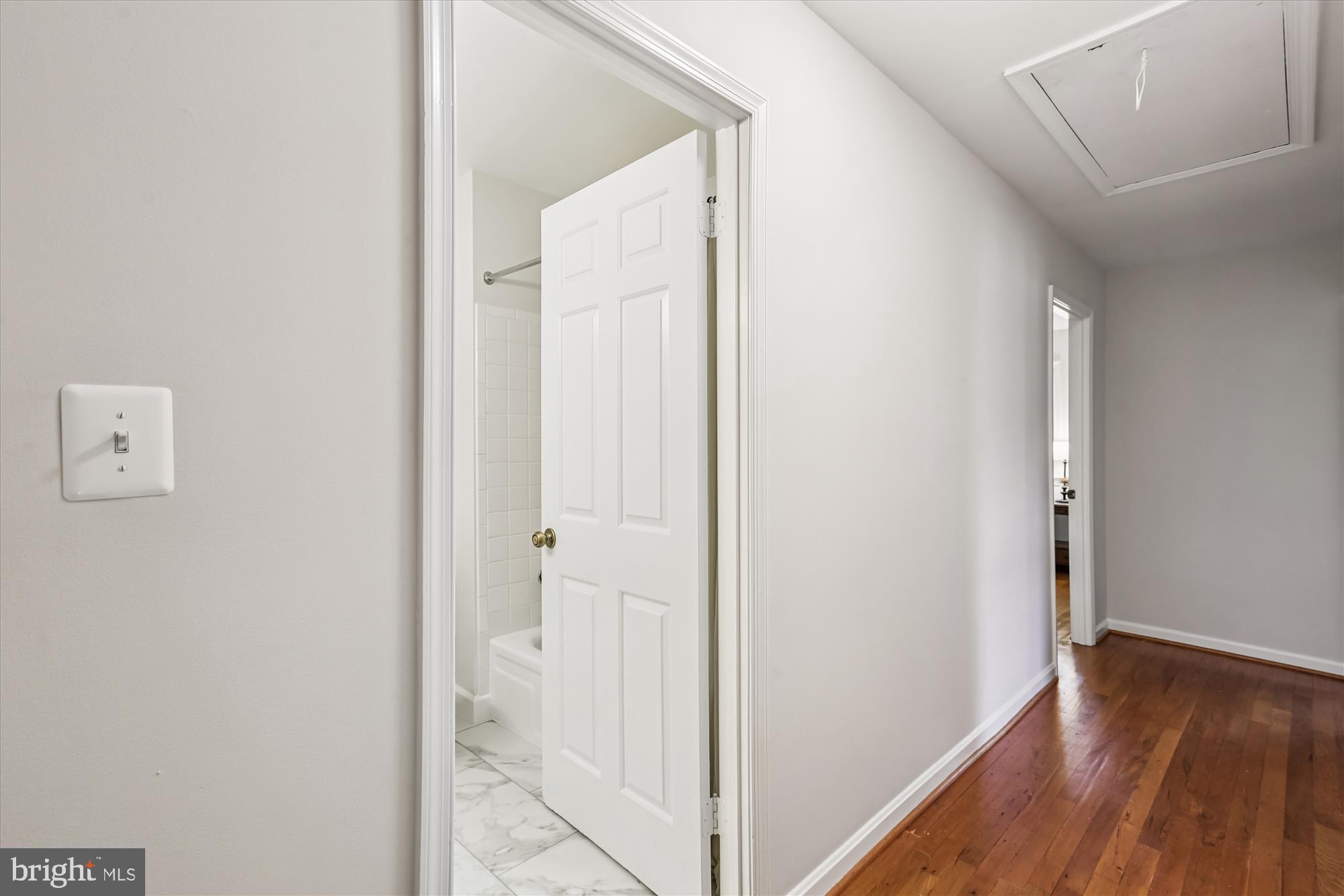 6734 Hillandale Road, Unit 9 Chevy Chase, MD 20815 - Photo 32 of 51 Upper-level hallway with hardwood flooring
