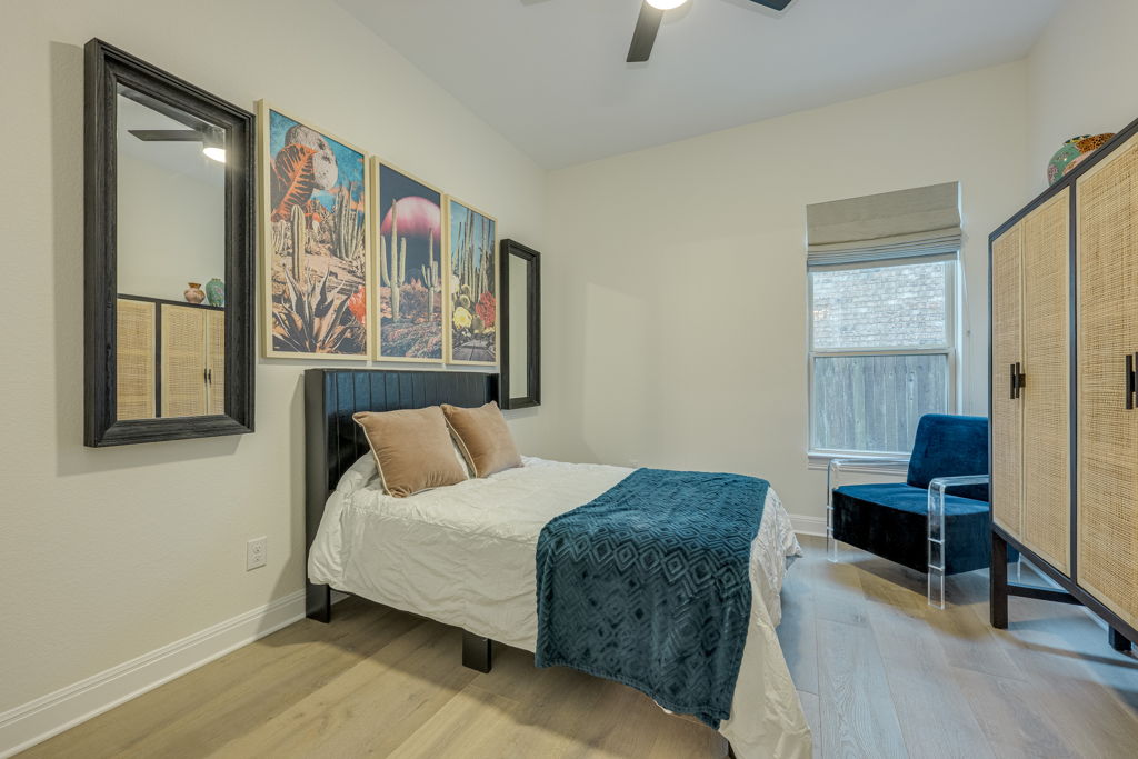 4209 Brean Down Road Pflugerville, TX 78660 - Photo 23 of 31 Well-lit sleeping quarters with a high ceiling, showcasing light wood flooring and a large window.